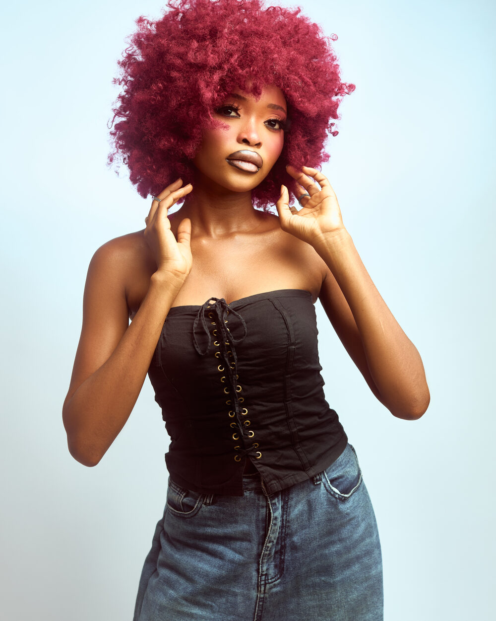 Editorial studio portrait, red afro and corset